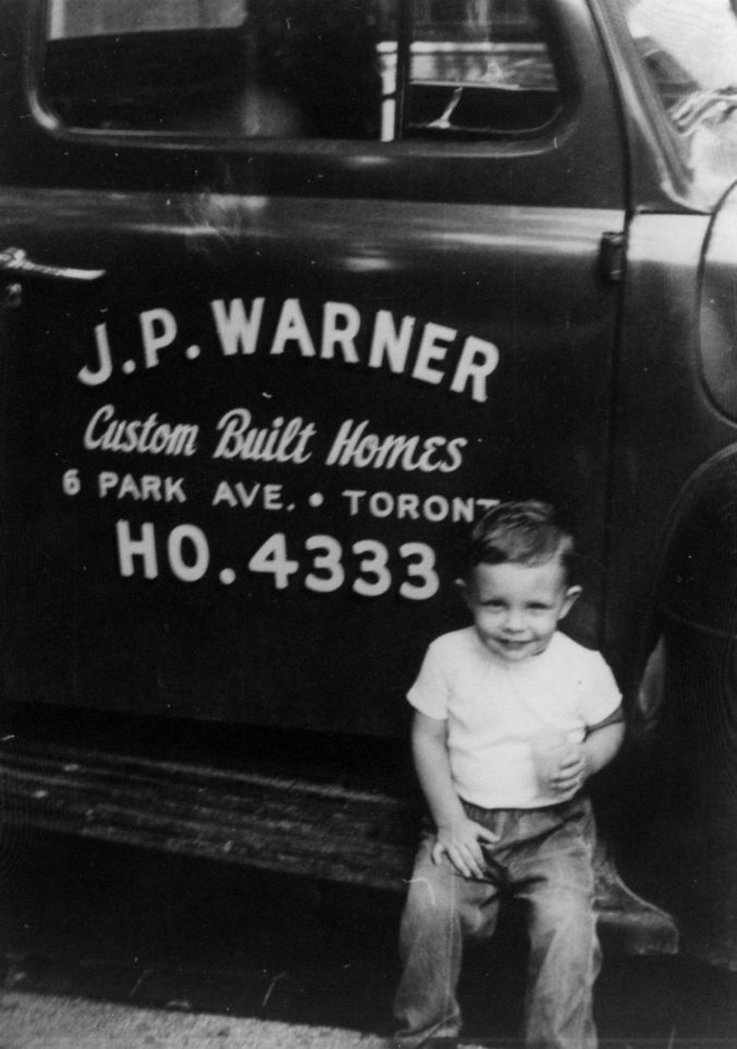 Paul sitting on the running board of his father's Ford pickup